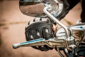 close-up on racing glove on motorcycle handle