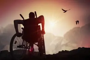 disabled man at sunset