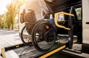 man in a wheelchair on a bus lift