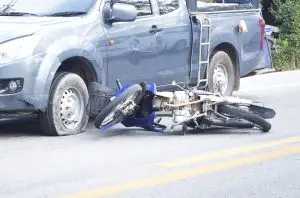 motorcycle crashed into blue pickup truck