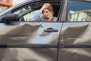 woman holding her head after a car crash