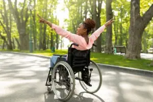 happy black woman in a wheelchair