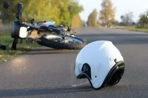 motorcycle and helmet crashed on road