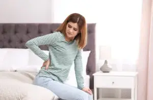 woman-in-bed-with-back-pain