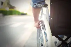 close-up on man’s hand on wheelchair