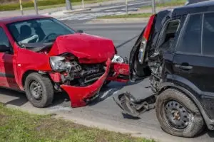 red and black cars in a rear-end collision