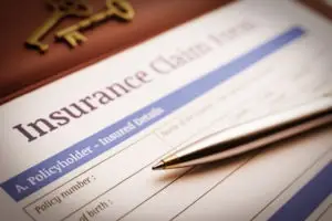 insurance claim with gold pen