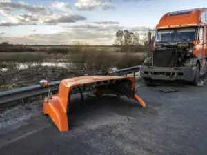 orange tractor-trailer with hood off