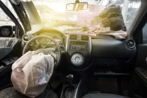 smashed car windshield with deployed airbag