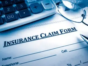 close-up on insurance claim form with calculator