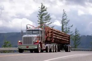 logging truck driving down the road