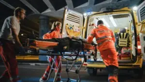 paramedics loading patient into ambulance