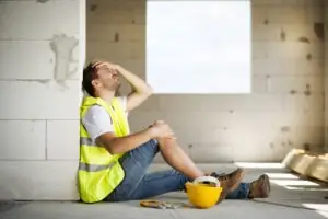 construction worker with hurt leg