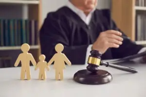 judge with wooden family figurines on desk