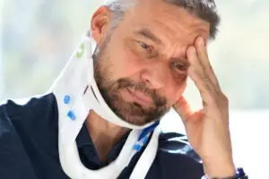 injured man wearing a neck brace after bus accident