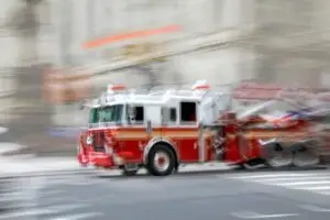 blurred image of a speeding fire truck just before an accident