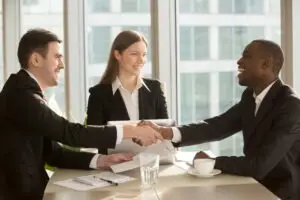 People shaking hands with an insurance agent. You can get help negotiating a settlement with The General Car Insurance today.
