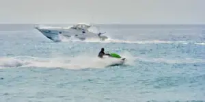 a boat and a jet ski on the water