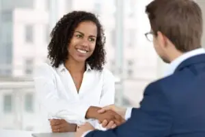 a Smyrna personal injury lawyer is shaking hands with a female client
