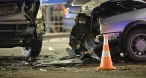 Two severely damaged cars are facing each other after a collision. A Valdosta car accident lawyer may be able to help.