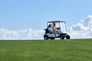 couple driving a golf cart