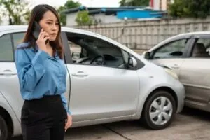 An injured woman calls her car accident lawyer from the accident scene to ask what to do after a car accident that is not your fault.