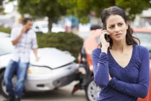 woman calling the police to file a crash report