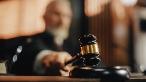 Court of Law and Justice Trial Session: Imparcial Honorable Judge Pronouncing Sentence, striking Gavel.