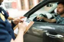 officer writing up a driver