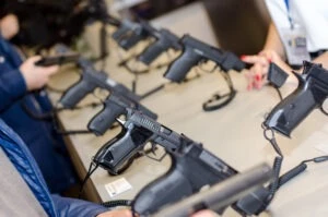 A line of guns at a gun show. Is gun ownership a state or federal issue?