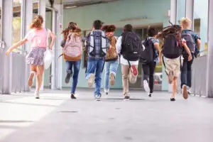 kids running into a school