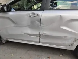 bashed-up silver car after a crash