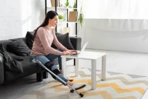 businesswoman with her leg in brace at work