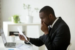 black man reviewing a demand letter