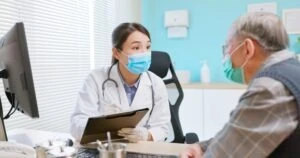 doctor and patient meeting with masks on