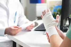 woman with a bandaged hand learning about the most common dog bite injuries in south carolina