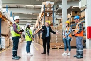 A boss explaining to his workers how workers’ compensation is calculated.