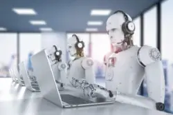 A row of white humanoid telemarketer robots wearing headsets and typing on computers illustrates AI's potential impact on call centers.