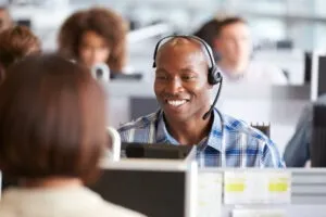 A law firm intake specialist working at a legal call center takes a call after completing the ultimate TCPA compliance checklist.