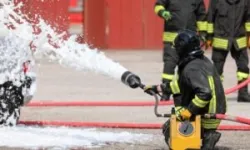 firefighters use a powerful jet of foam to put out the fire after the traffic accident
