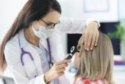 Doctor Examining Patient for Hearing Loss