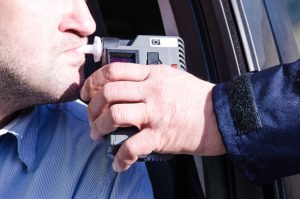 man taking a breathalyzer