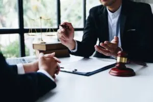 Lawyer sits across desk from client and explains why a case would be dismissed without prejudice