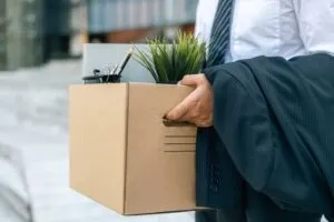 A man carrying out his belongings after losing his job. He got a California DUI conviction.