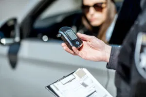 A police officer in California checks to see if this driver is DUI for the fifth time. If she is, she may be facing a felony charge.