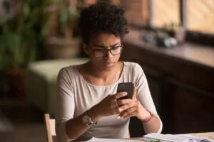 A woman using her phone to research if a wet reckless affects employment. 