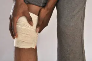 a boy with an injured knee in a bandage