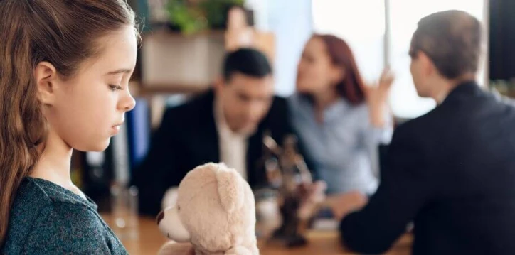 child holding stuffed animal during family law meeting about child custody