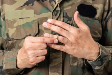 hands of military member taking off their ring