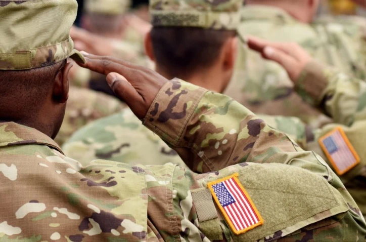 Soldiers standing in formation saluting